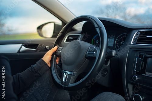 Close-up of young driver behind the wheel. © Lalandrew