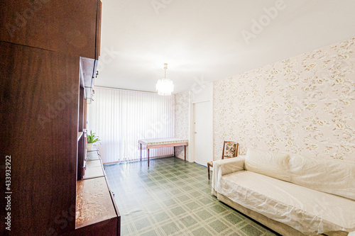 Russia, Moscow- April 28, 2020: interior room apartment bright cozy atmosphere. general cleaning, home decoration, preparation of house for sale. living room with sofa. lamp chandelier on the ceiling