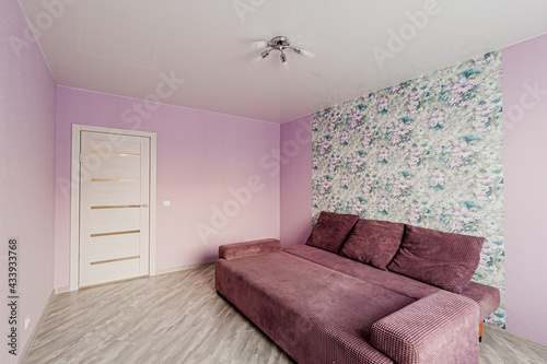 Russia  Moscow- April 28  2020  interior room apartment bright cozy atmosphere. general cleaning  home decoration  preparation of house for sale. living room with sofa. lamp chandelier on the ceiling