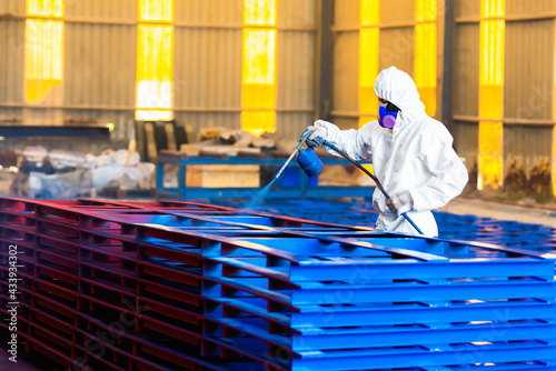 Airless Spray Painting, Worker painting on steel structure fabricated surface by airless spray gun for protection rust and corrosion.