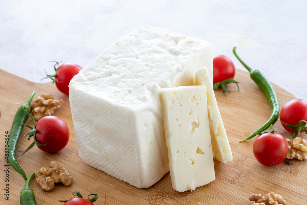 ripened cow cheese on wooden background