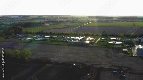 Sewage treatment plant seen from above during sunset.