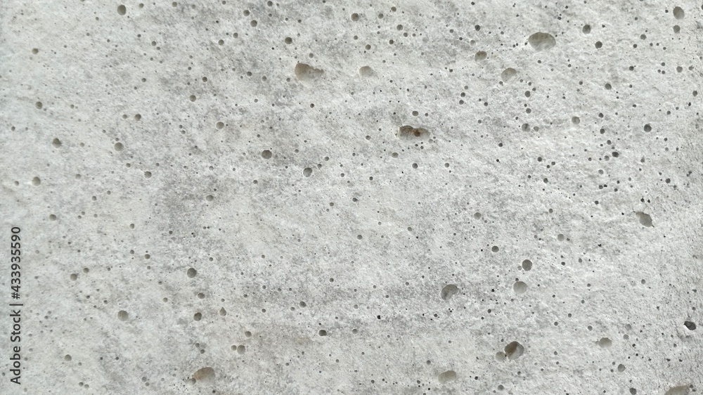 Gray concrete surface has rough pores as a background. Gray concrete surface has rough pores as a background.