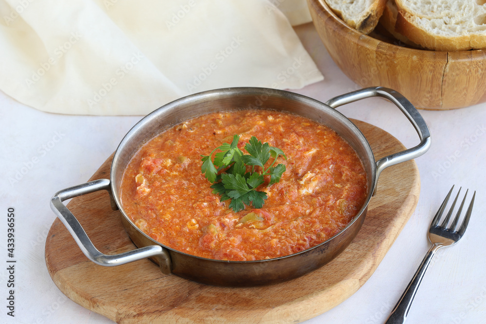 Tomato and peppered egg on wooden background. Local name menemen Tomato and peppered egg on wooden background. Local name menemen