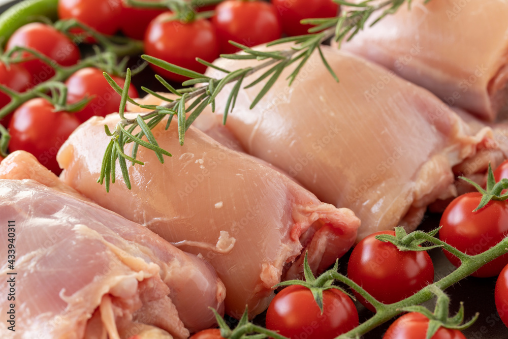 Raw boneless chicken thigh on a white wooden background. Chicken Meat background. Meat close-up