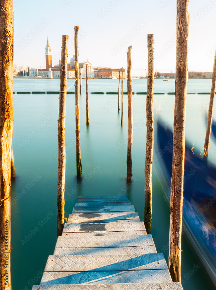 Gondolas and pier over Venice lagoon