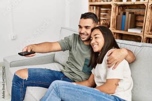 Young latin couple smiling happy watching tv at home. © Krakenimages.com