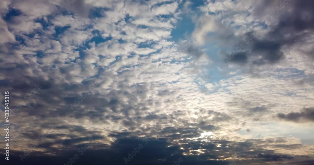 Clouds timelapse on sunset sky with moving sunset clouds. 4K timelapse