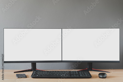 Front view of a double blank white display.There is a mobile phone, mouse, keyboard, devices for working during the coronavirus..Work from home concept