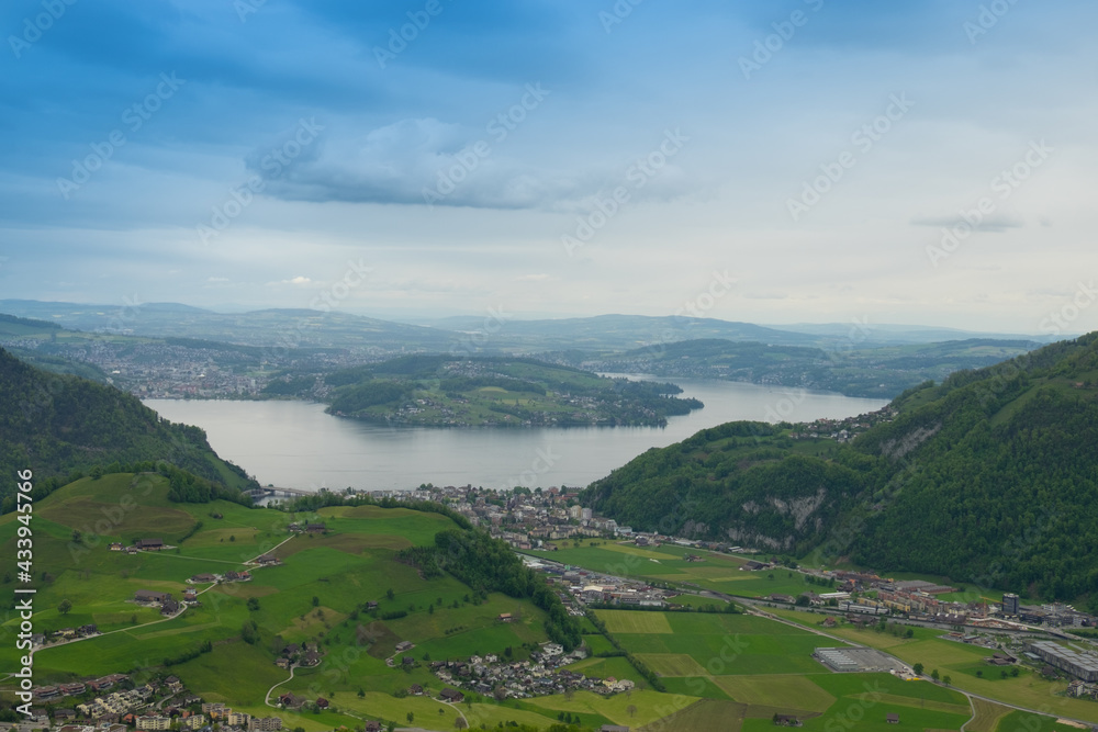 Naklejka premium Landscape view of the valley of Stans, with a lake in the background, shot in Stanserhorn, Nidwald, Switzerland