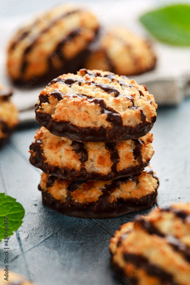 Coconut macaroons cookies with drizzle of chocolate served with glass of milk. Gluten free