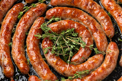 Homemade Pork Sausages in rustic pan with thyme