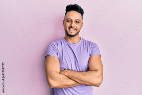 Young arab man wearing casual clothes happy face smiling with crossed arms looking at the camera. positive person.