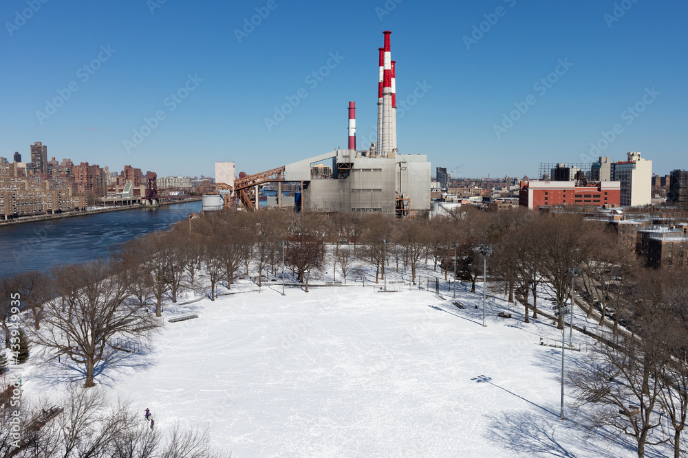 Queensbridge Park in Long Island City Queens Covered in Snow during Winter with a Power Plant