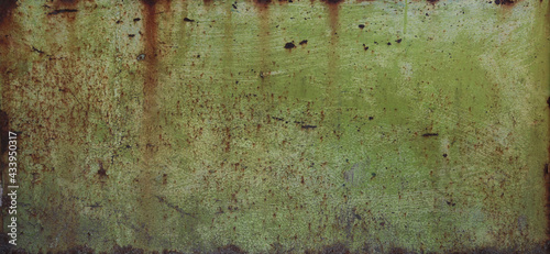 weathered and rusty metal surface with military green tones - worn steampunk background with scratches	