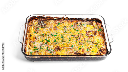 Baked potatoes with cheese in baking sheet isolated on a white background.