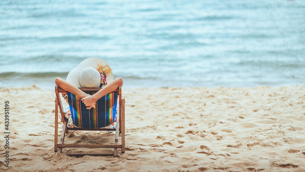 Happy traveler asian woman relax on chair beach in summer Thailand Happy traveler asian woman relax on chair beach in summer Thailand
