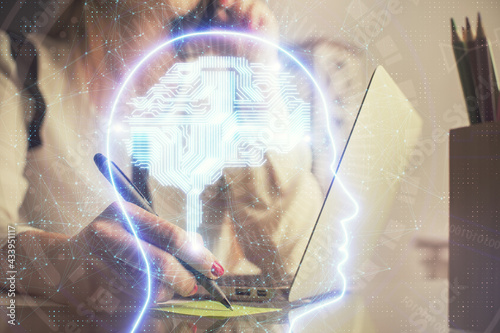 Multi exposure of woman hands working on computer and human brain hologram drawing. Ai tech concept.