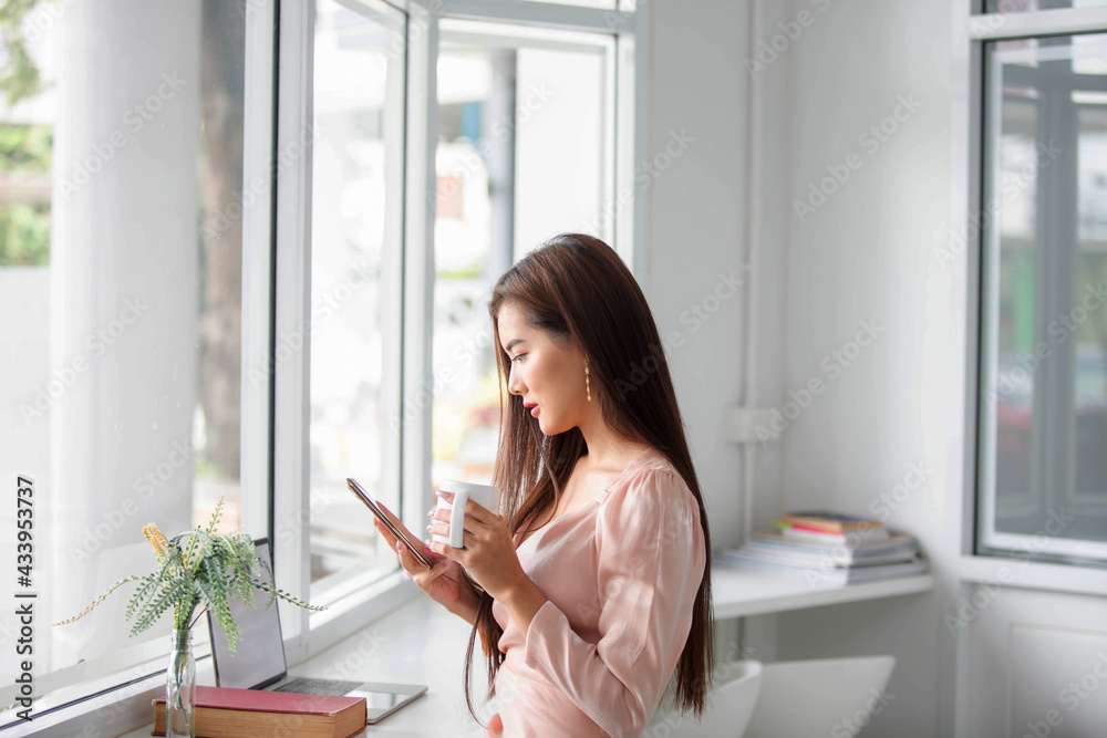 Asian women are using computers to work at home. According to the government's policy of working at home Caused by the Covid virus Asian women are using computers to work at home. According to the government's policy of working at home Caused by the Covid virus