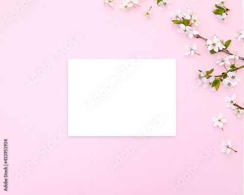Horizontal blank card mockup on pink floral background for greeting card, invitation, letter, note paper, stationery design. © IndrePau