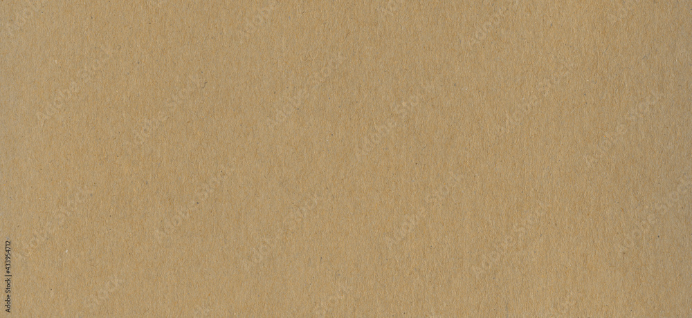 Clean brown cardboard paper background texture. Horizontal banner Clean brown cardboard paper background texture. Horizontal banner