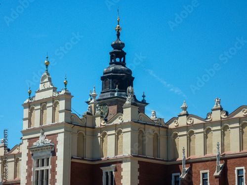A close up on the rooftop of The Krak?w Cloth Hall in Cracow, Poland. There is one high tower on top. Medieval architectural style. Clear and blue sky.