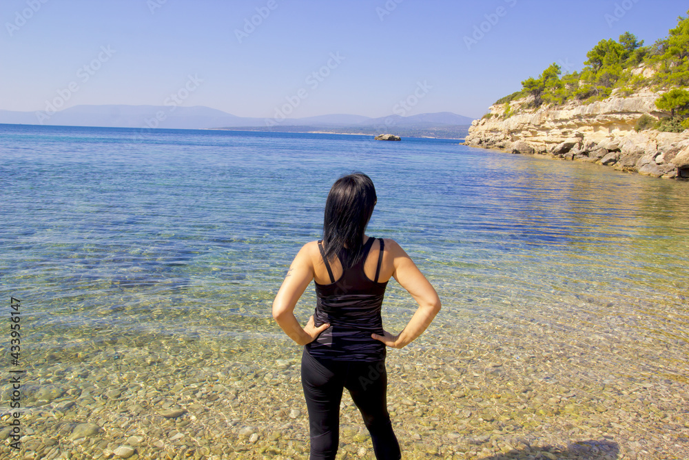 young woman standing on the beach in sigacik izmir