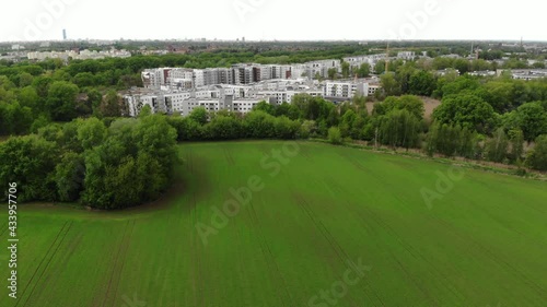 Aerial shot of housing estate near young wheat field in Europe