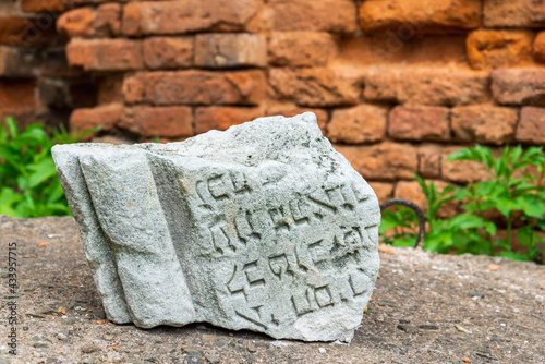 Stryi, Ukraine - 15.05.2021: Inscription on the stone on the yiddish at the Ruins of The Great Synagogue in Stryi.