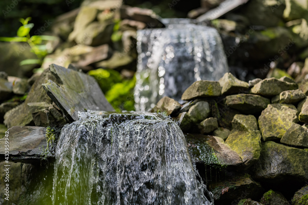 Two small waterfalls in the forest. Water, rocks and leafs. Soft background. Two small waterfalls in the forest. Water, rocks and leafs. Soft background.