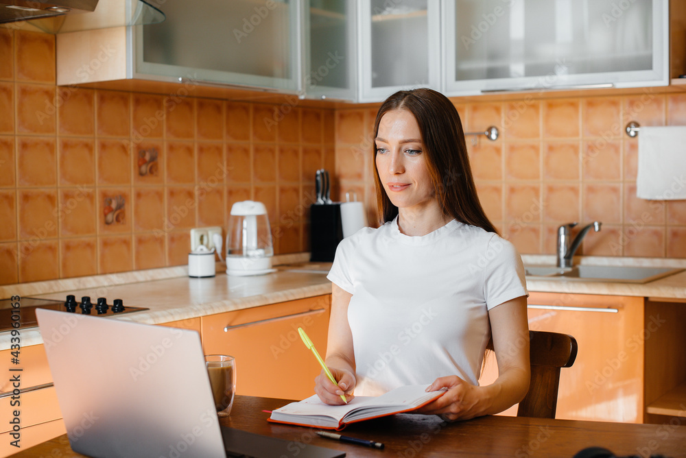 A young girl works at home on a remote site. Distance learning. Stay at home A young girl works at home on a remote site. Distance learning. Stay at home