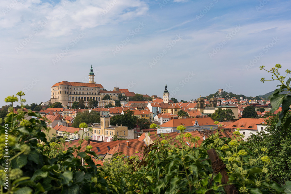 View of Mikulov through the leaves with Castle in South Moravia, Czech Republic. Photo is taken from nearby hill.