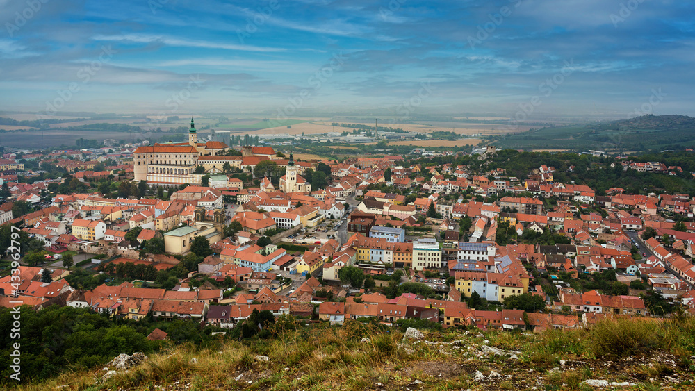 Panoramic view of Mikulov with Castle in South Moravia, Czech Republic. Photo is taken from nearby hill. Stone in foreground.