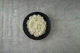 black plate with cooked rice on the table