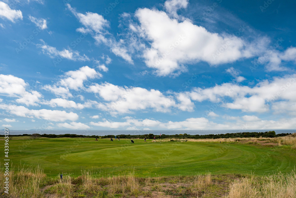 Seaside golf course on sunny day with cloudy sky. Seaside golf course on sunny day with cloudy sky.