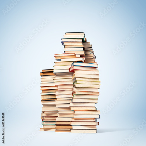 Tall stacks of old paper books on blue background. File contains a path to isolation.