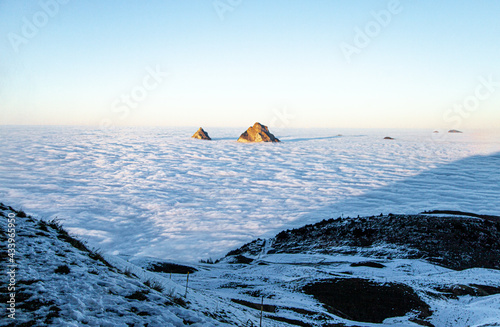 Mythen peaking over sea of clouds photo