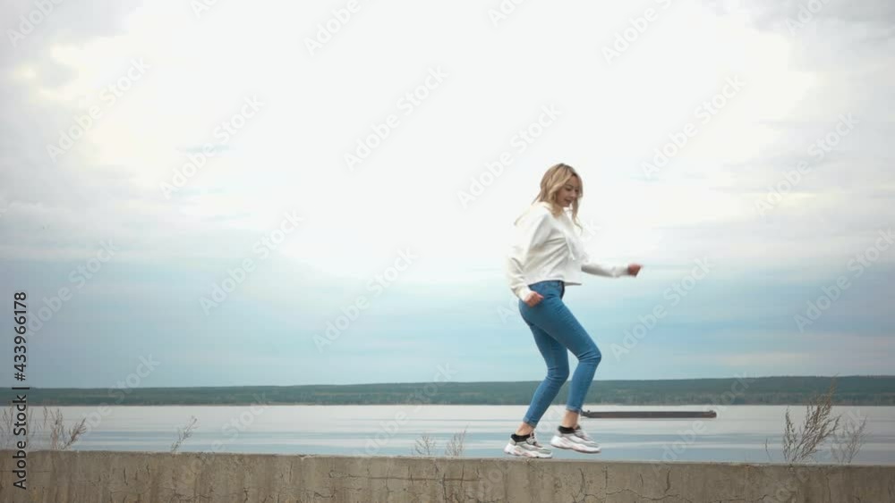 Funny young girl walks and dances in nature. Attractive Funny young girl walks and dances in nature. Attractive