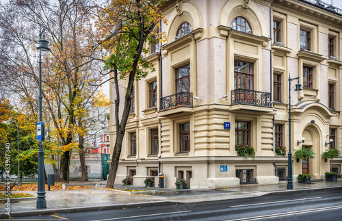 House 17 on Ostozhenka Street and the dome of the Cathedral in the Conception Monastery among the trees in Moscow