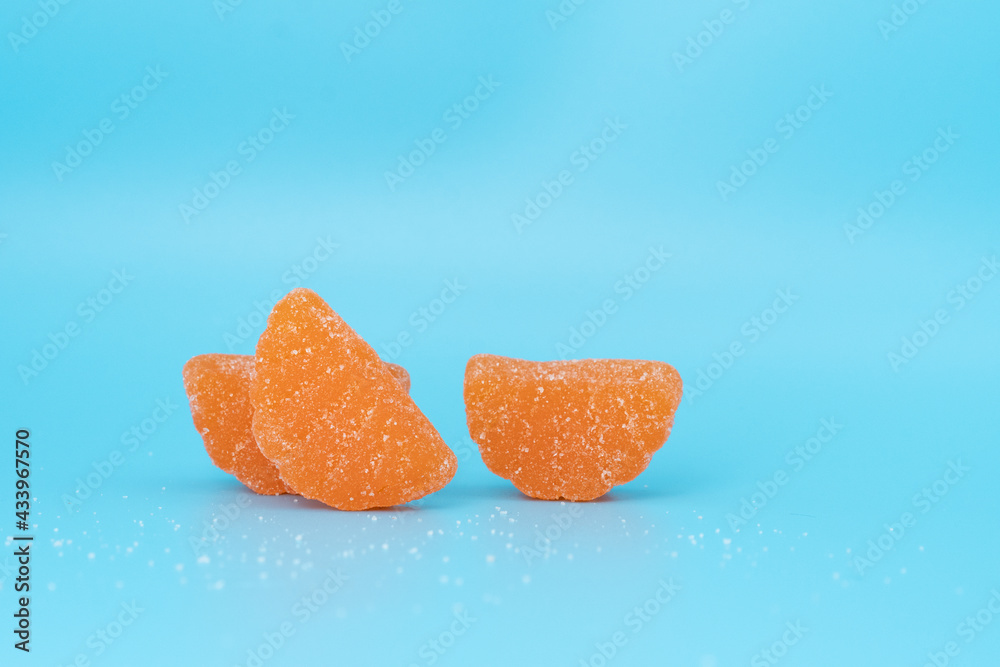 Candy orange slices on blue background Candy orange slices on blue background