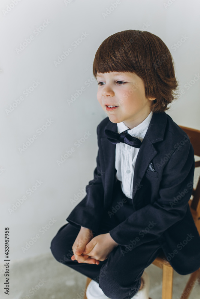 Little boy in suit and tie on white background. Childhood, fashion kids concept Little boy in suit and tie on white background. Childhood, fashion kids concept