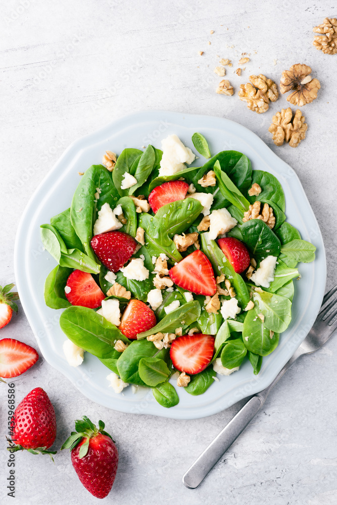 Healthy salad with strawberries, walnuts and cheese, top view Healthy salad with strawberries, walnuts and cheese, top view