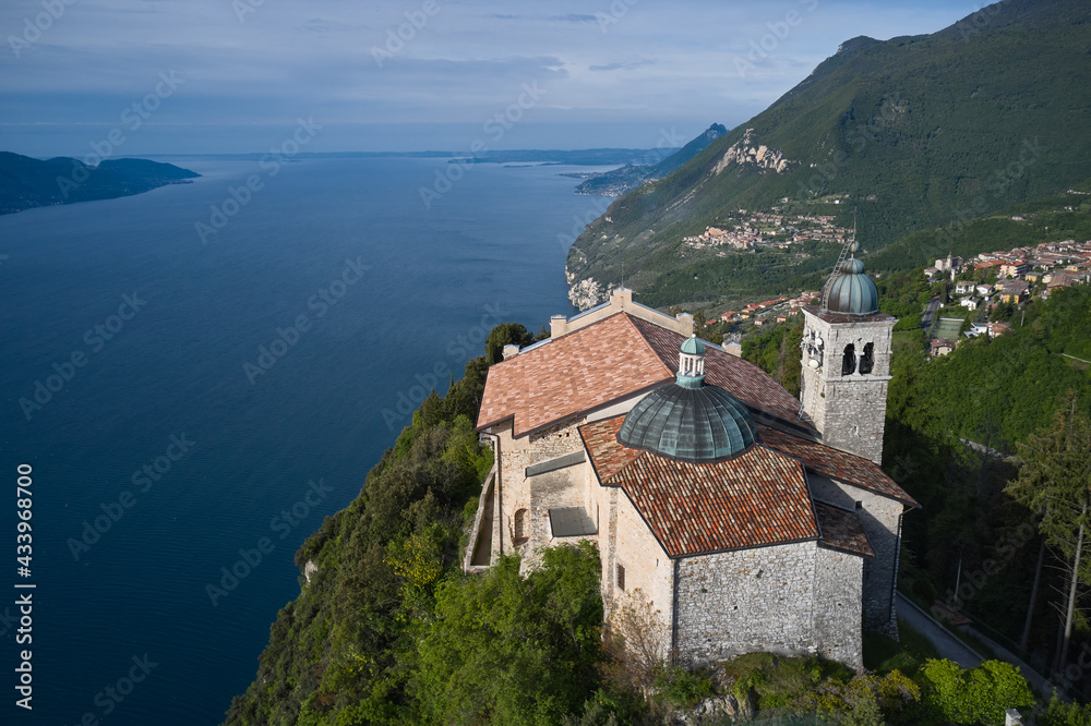 Top view of the Eremo di Montecastello church. Aerial panorama of Montecastello. Catholic Church Eremo di Montecastello. Lake Garda, Italy. Aerial view of the church on the mountain.