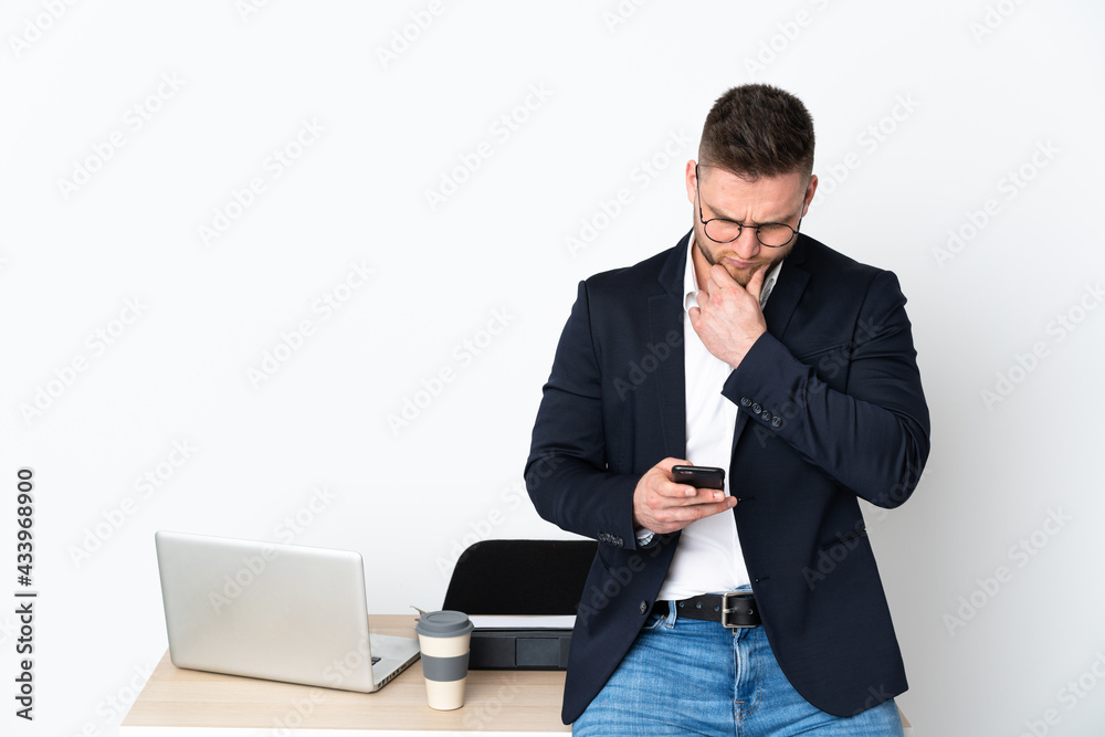 Russian man in a office isolated on white background thinking and sending a message Russian man in a office isolated on white background thinking and sending a message