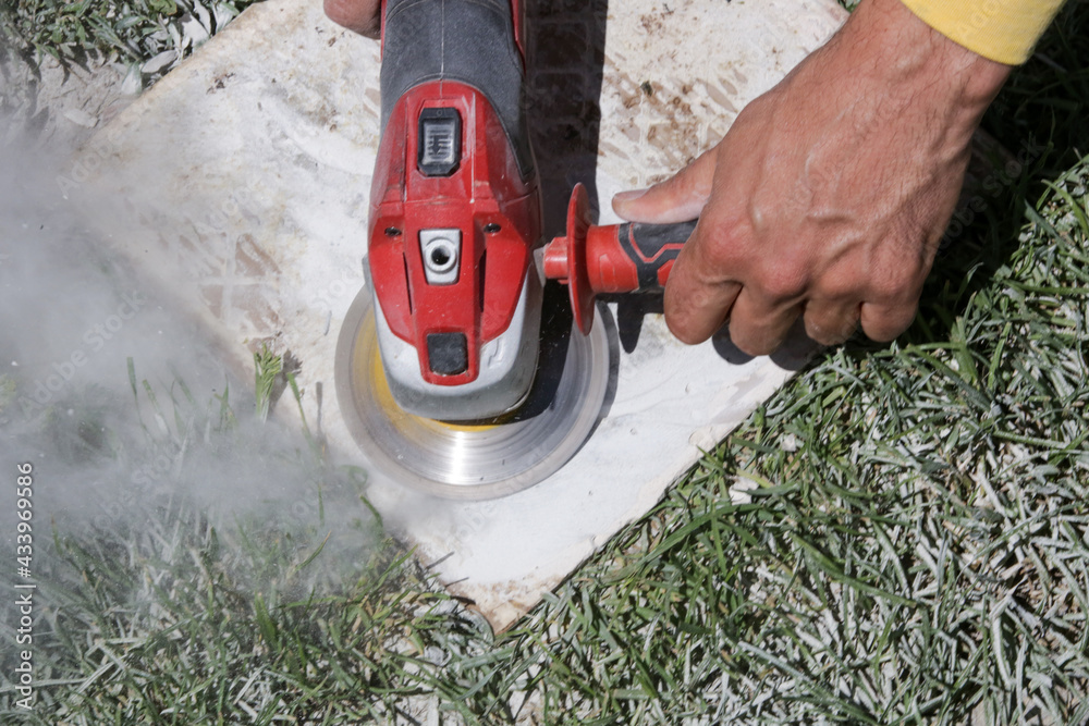 Removing mortar and glue from old tiles for reuse. Stock Photo Adobe