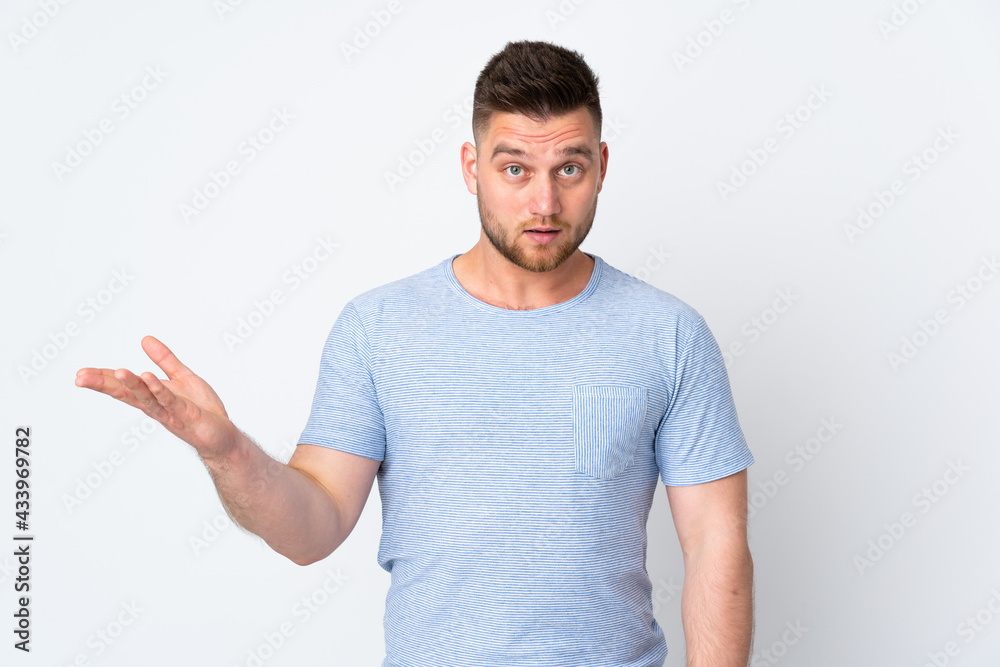 Russian handsome man over isolated background making doubts gesture Russian handsome man over isolated background making doubts gesture