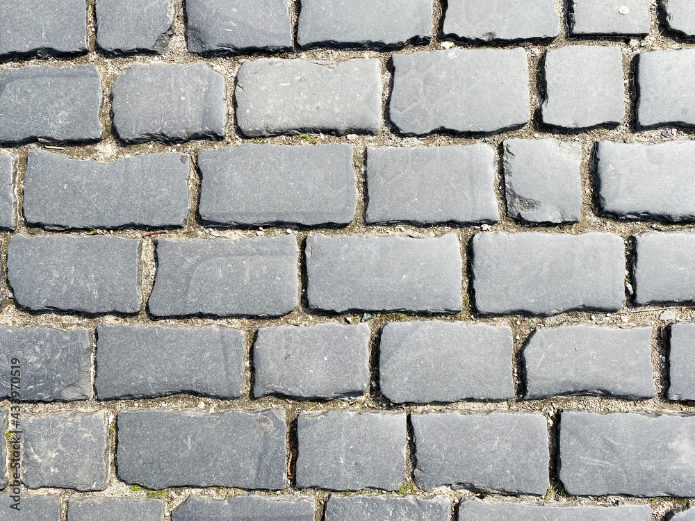 The background of the brick paving slabs is gray. Sidewalk tiles close-up The background of the brick paving slabs is gray. Sidewalk tiles close-up