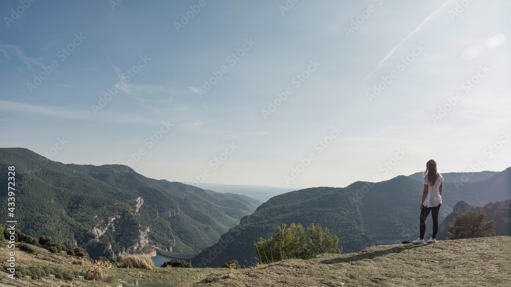 Obraz premium young hiker girl up all over the mountain looking at the landscape