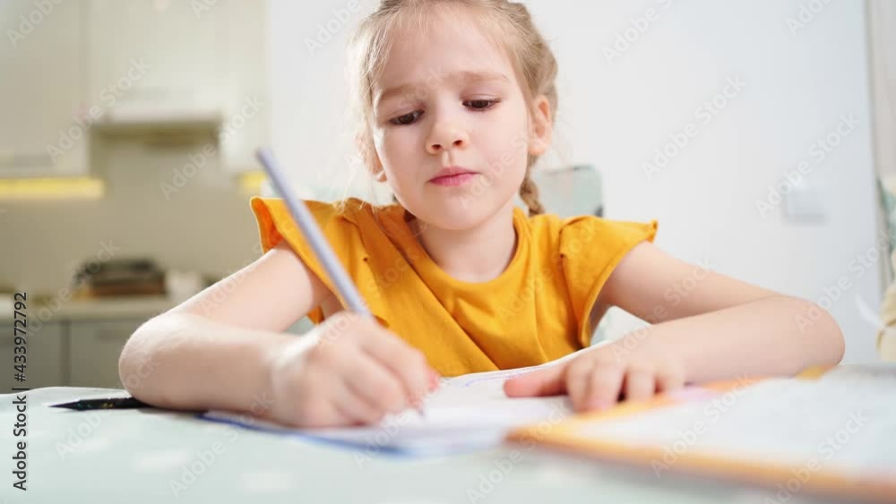 A little schoolgirl does her homework and waving his tired hand. complexities of correct and beautiful handwriting. there is no desire to learn. family and distance learning. A little schoolgirl does her homework and waving his tired hand. complexities of correct and beautiful handwriting. there is no desire to learn. family and distance learning.