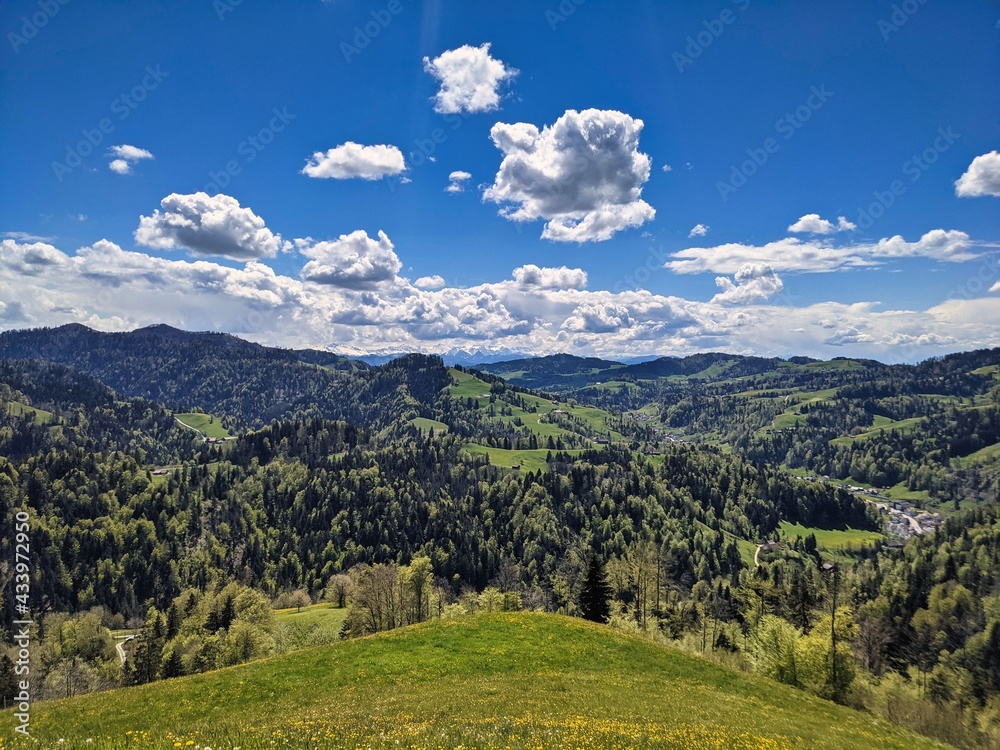 Fototapeta premium View in the Zurich Oberland of the surrounding hills in this beautiful spring season. foresight in the mountains. Steg